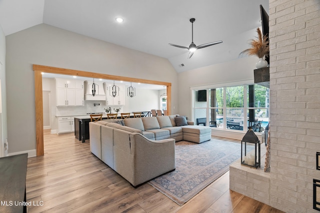4270 Sunset Rd, Nesbit, MS 38651 - living area featuring lofted ceiling, light wood-style flooring, visible vents, baseboards, and a ceiling fan