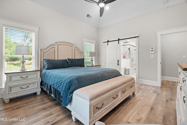 4270 Sunset Rd, Nesbit, MS 38651 - bedroom with visible vents, a barn door, light wood-type flooring, and ceiling fan