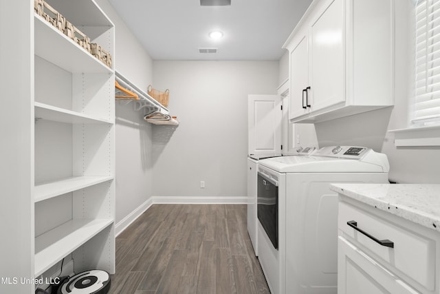 4270 Sunset Rd, Nesbit, MS 38651 - washroom with washing machine and clothes dryer, visible vents, dark wood-style floors, baseboards, and cabinet space