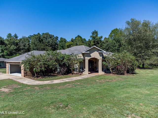 view of front of property featuring a garage, a front lawn, and concrete driveway