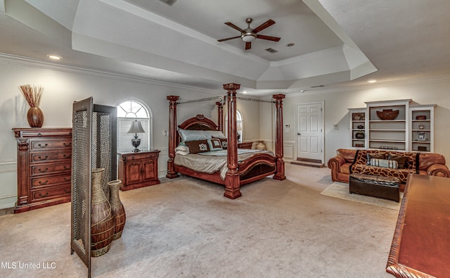 bedroom featuring light carpet, crown molding, ceiling fan, and a raised ceiling