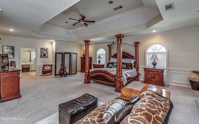 bedroom with light carpet, ceiling fan, crown molding, and a raised ceiling