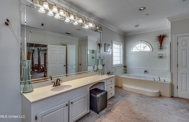 bathroom with vanity, a bathtub, and ornamental molding