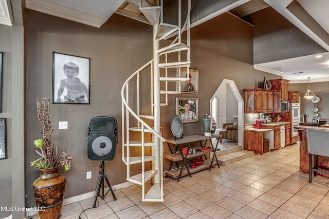 staircase featuring baseboards, crown molding, and tile patterned floors