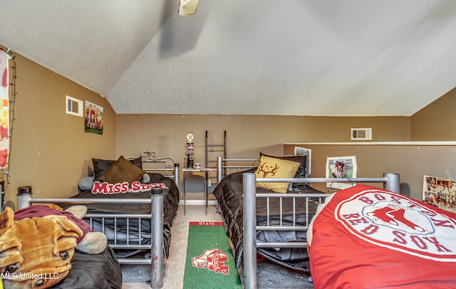 carpeted bedroom with a textured ceiling and vaulted ceiling