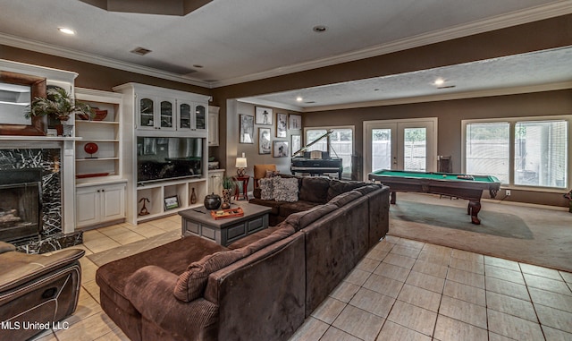 living room featuring light tile patterned floors, visible vents, crown molding, pool table, and a high end fireplace