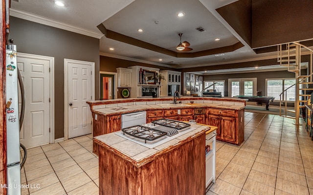 kitchen featuring white appliances, sink, pool table, tile countertops, and a large island