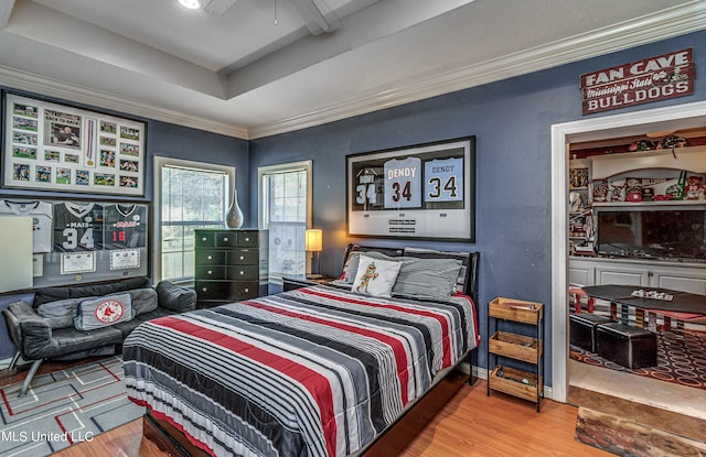 bedroom featuring ceiling fan, ornamental molding, and hardwood / wood-style floors