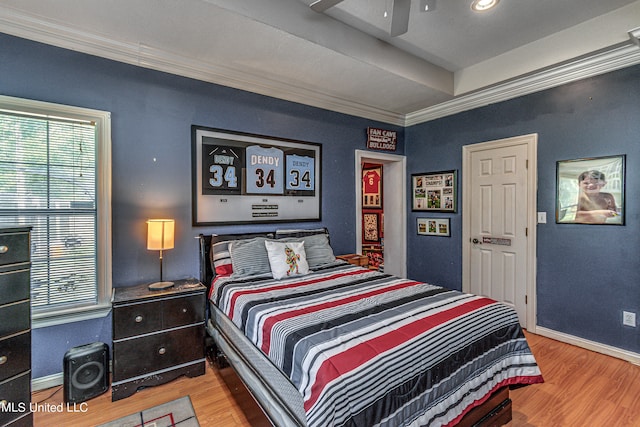 bedroom with ornamental molding, hardwood / wood-style flooring, and ceiling fan