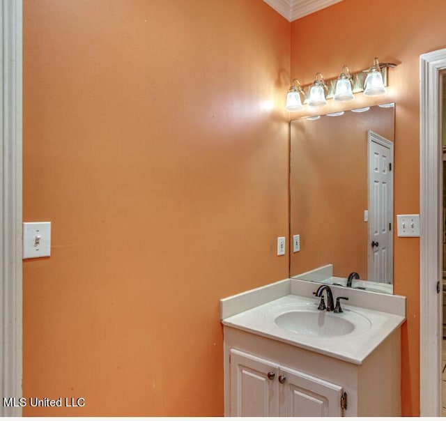 bathroom with crown molding and vanity