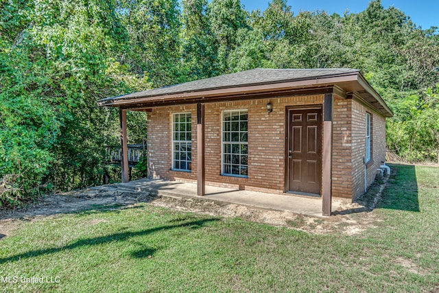 view of outbuilding with a lawn