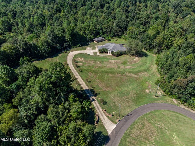 bird's eye view featuring a wooded view