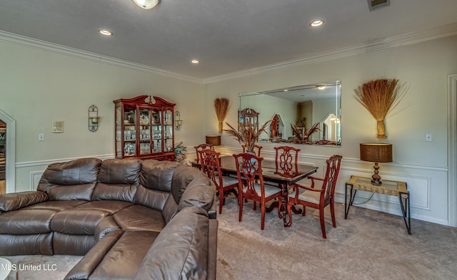 carpeted living area featuring wainscoting, ornamental molding, visible vents, and recessed lighting