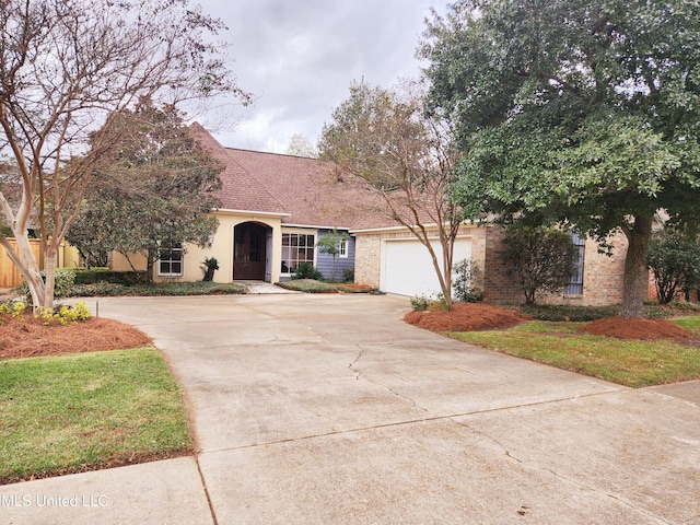 view of front of property with a garage and a front yard