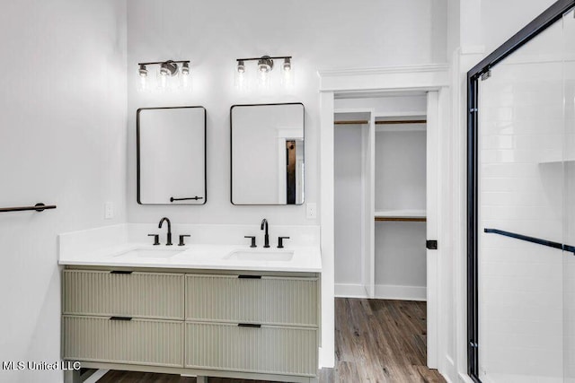 414 Shell St, Biloxi, MS 39530 - bathroom with a shower stall, double vanity, wood finished floors, and baseboards