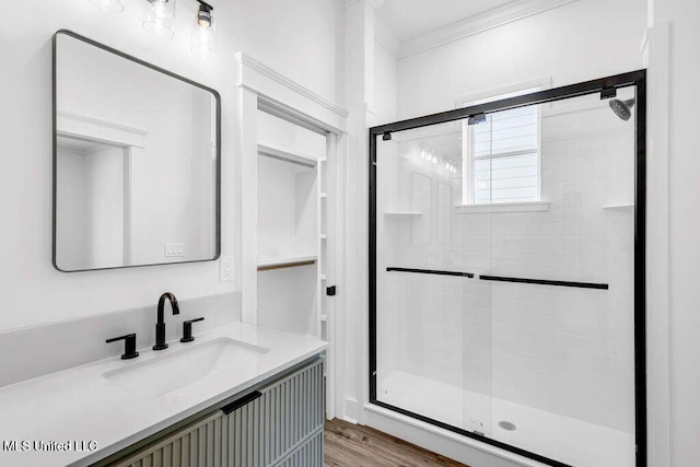 414 Shell St, Biloxi, MS 39530 - full bathroom featuring a stall shower, ornamental molding, vanity, and wood finished floors
