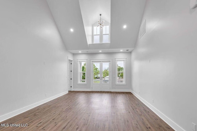 414 Shell St, Biloxi, MS 39530 - unfurnished living room with high vaulted ceiling, baseboards, wood finished floors, recessed lighting, and a chandelier