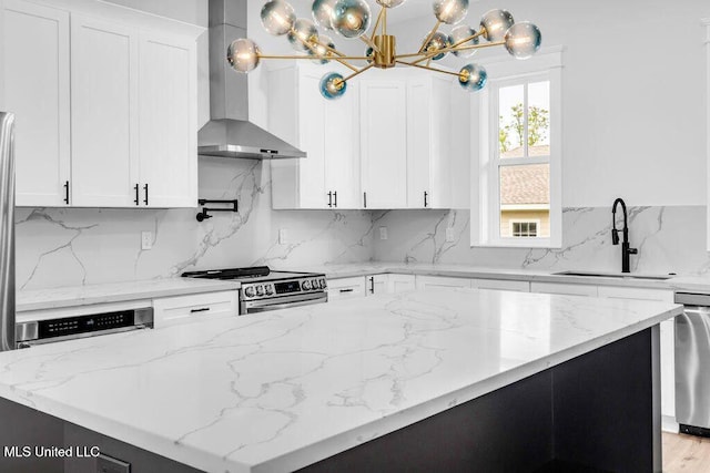 414 Shell St, Biloxi, MS 39530 - kitchen with wall chimney exhaust hood, a sink, stainless steel appliances, a center island, and a chandelier