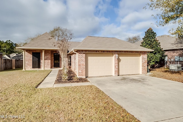 single story home with a garage and a front lawn