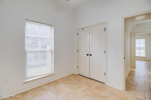 unfurnished bedroom with a closet and light tile patterned flooring