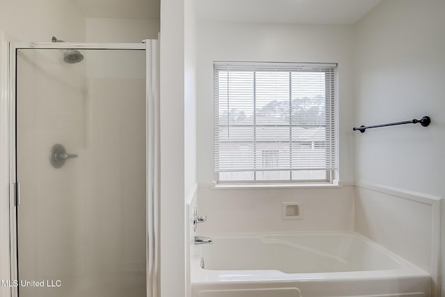 bathroom with shower with separate bathtub