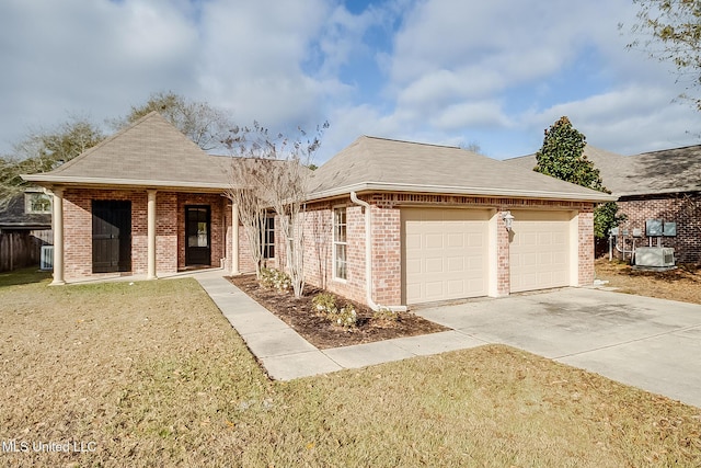 single story home with a garage and a front lawn