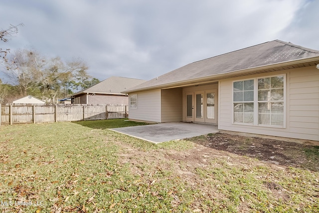 back of house featuring a patio area and a yard