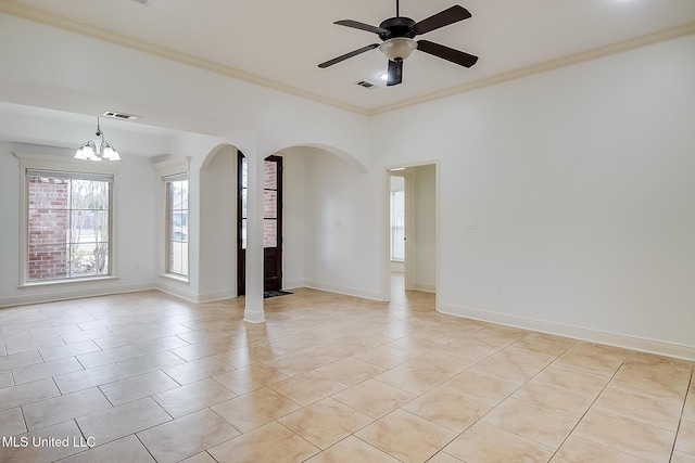 tiled spare room with ceiling fan with notable chandelier and crown molding