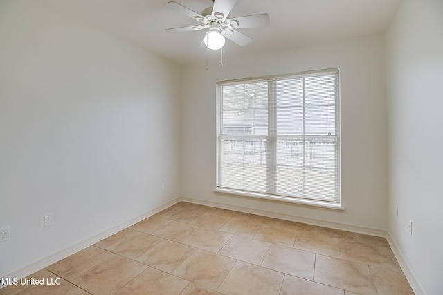 spare room with ceiling fan and light tile patterned floors