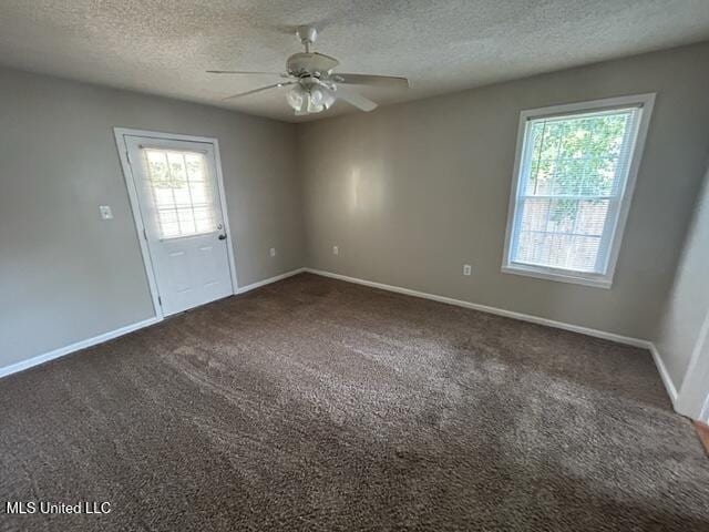 carpeted empty room featuring a textured ceiling and ceiling fan