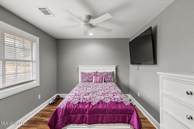 bedroom with dark wood-type flooring and ceiling fan