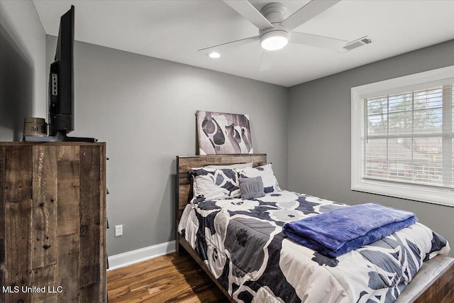 bedroom featuring ceiling fan and dark hardwood / wood-style flooring