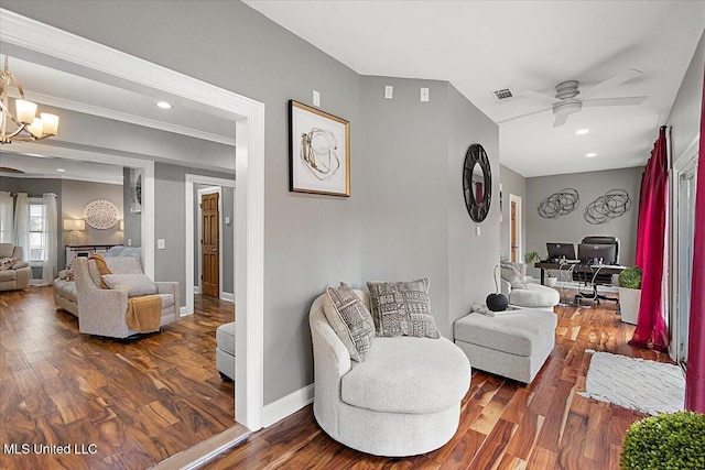 living room featuring ceiling fan with notable chandelier and dark hardwood / wood-style floors