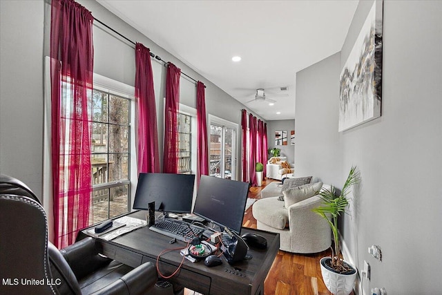 office with hardwood / wood-style flooring and ceiling fan