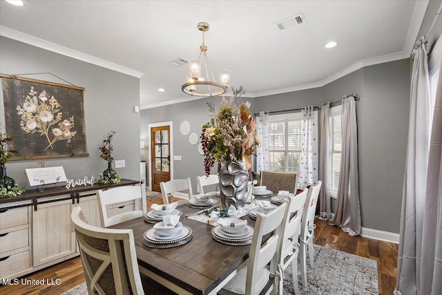 dining room with crown molding, a notable chandelier, and dark hardwood / wood-style flooring