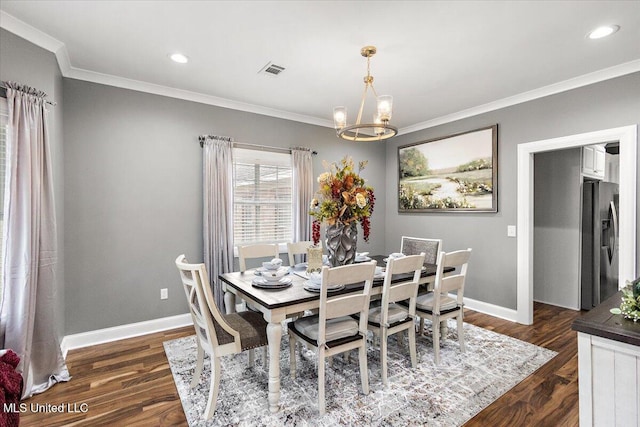 dining area with crown molding, dark wood-type flooring, and a chandelier