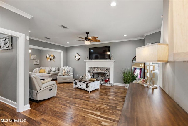 living room featuring dark wood-type flooring, ceiling fan, and ornamental molding