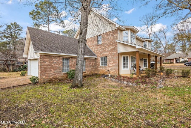 view of home's exterior featuring a porch, a garage, and a lawn