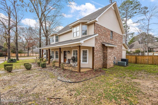 view of front of house with a front yard and central AC unit