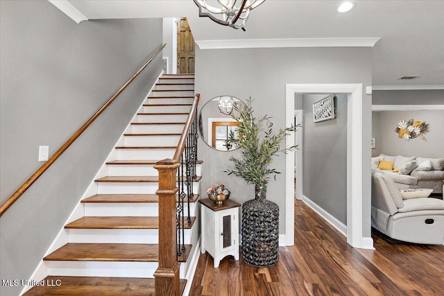 stairs featuring wood-type flooring and ornamental molding