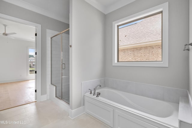 bathroom featuring a garden tub, baseboards, ceiling fan, and a stall shower