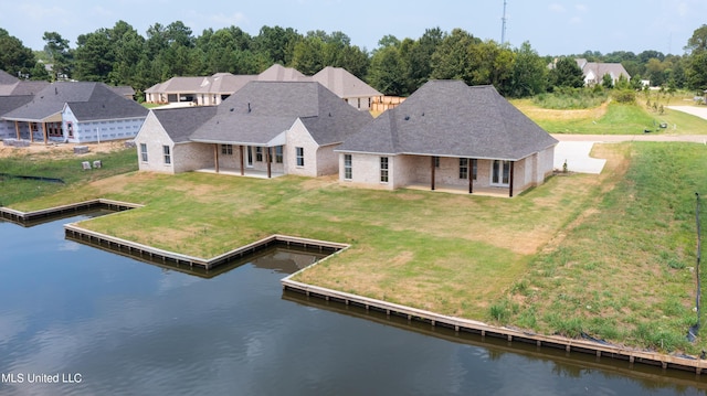 back of house featuring a water view and a patio