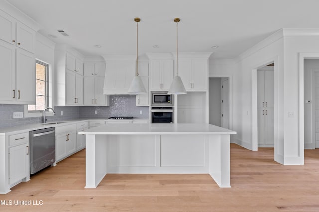 kitchen featuring stainless steel appliances, a sink, a center island, white cabinetry, and custom range hood