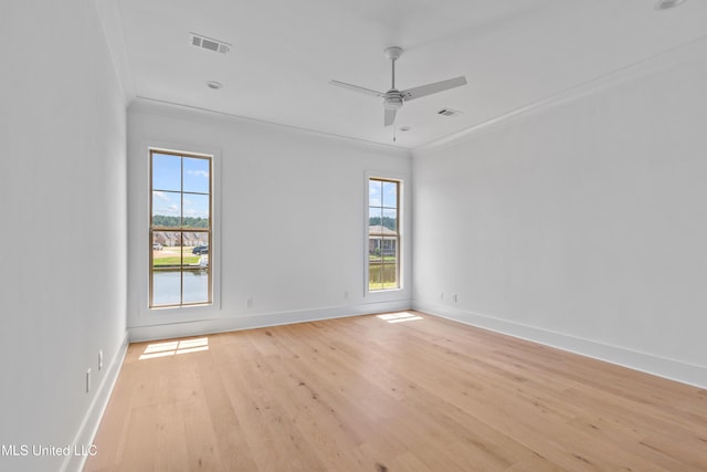 spare room with visible vents, ornamental molding, and a healthy amount of sunlight