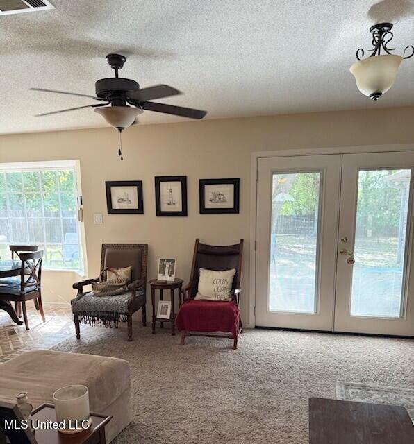 2246 Baywood Dr, Biloxi, MS 39532 - living area featuring french doors, a textured ceiling, ceiling fan, and carpet floors