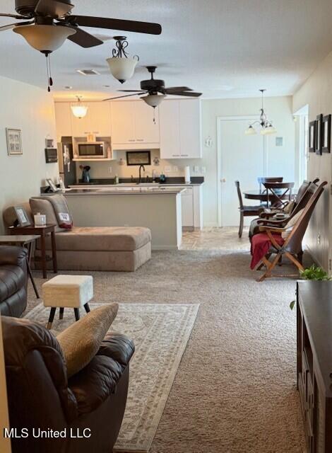 2246 Baywood Dr, Biloxi, MS 39532 - living room featuring ceiling fan and light colored carpet