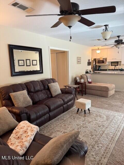 2246 Baywood Dr, Biloxi, MS 39532 - carpeted living area featuring a ceiling fan