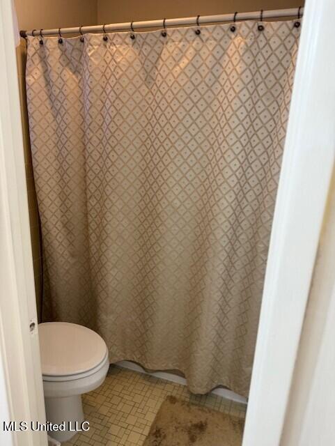 2246 Baywood Dr, Biloxi, MS 39532 - bathroom with toilet and curtained shower