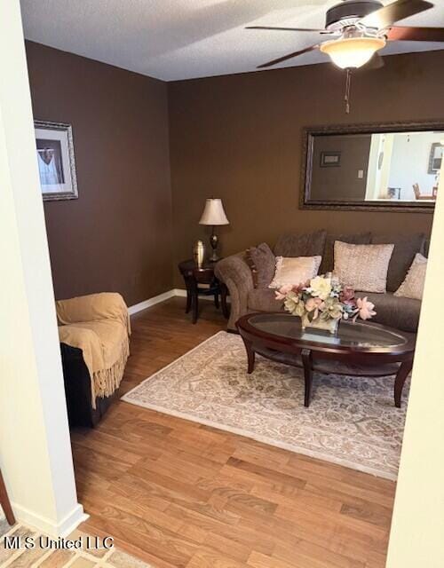 2246 Baywood Dr, Biloxi, MS 39532 - living room with wood finished floors, a ceiling fan, and baseboards