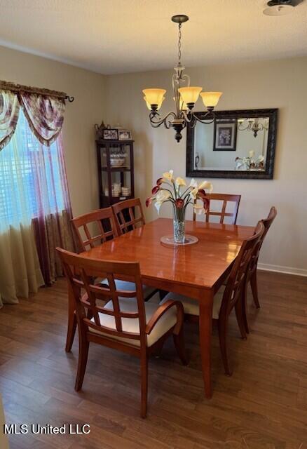 2246 Baywood Dr, Biloxi, MS 39532 - dining area featuring a chandelier, wood finished floors, and baseboards